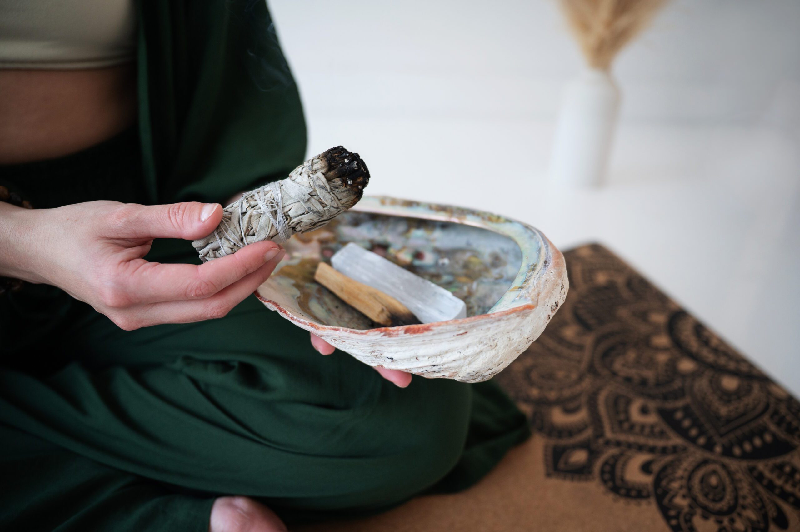 Smudging ritual with sage and selenite